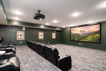 A home theater with a large screen and comfortable seating.